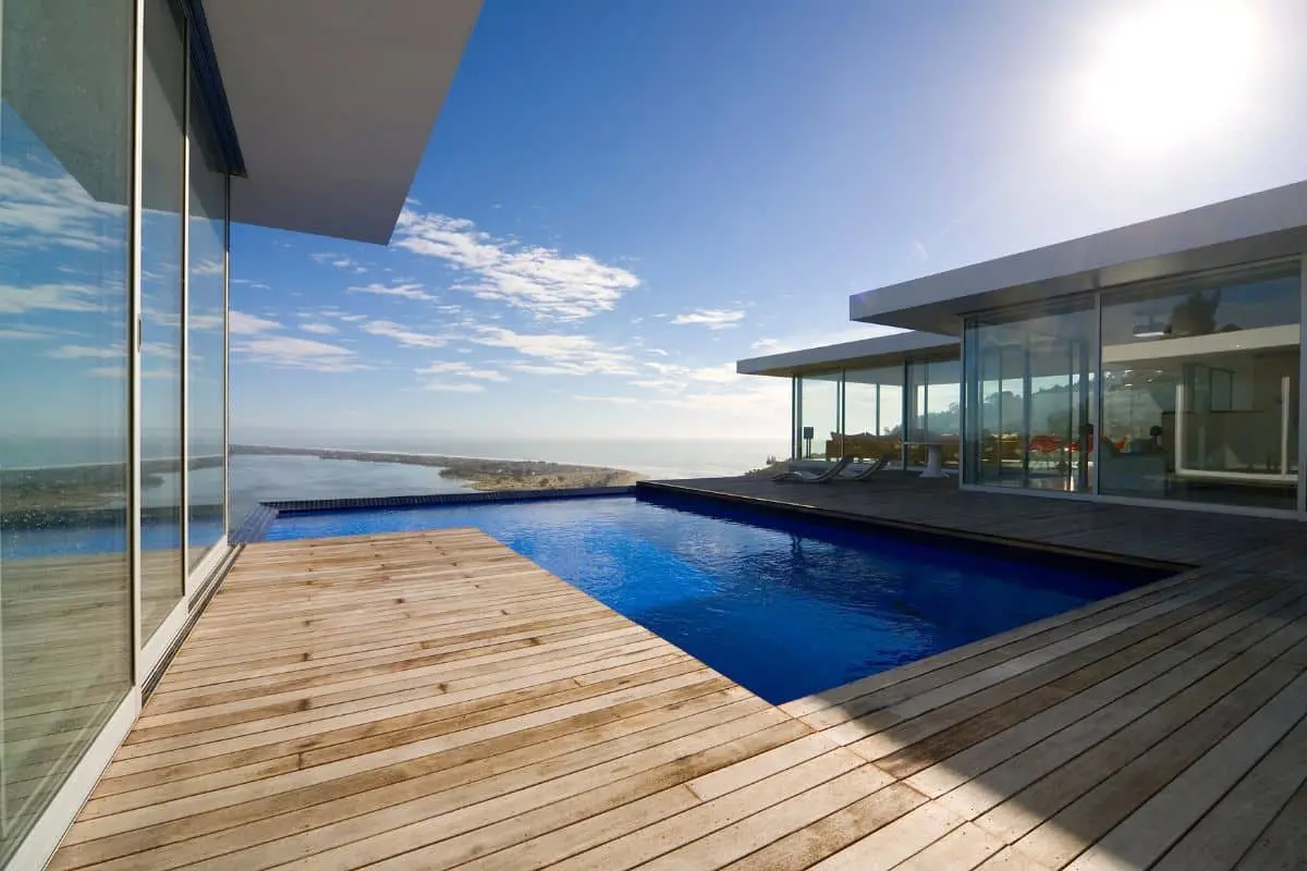 Modern Orange County pool deck with professional waterproof deck coating and ocean view