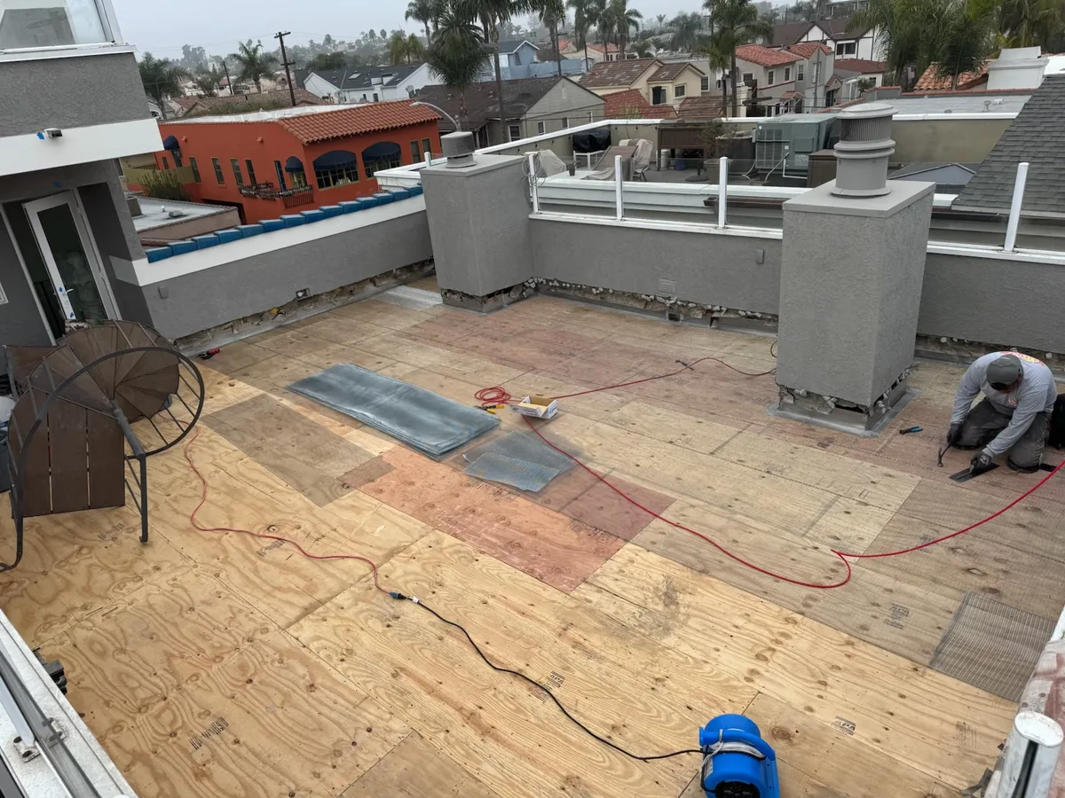 Tile deck waterproofing membrane installation on a rooftop deck