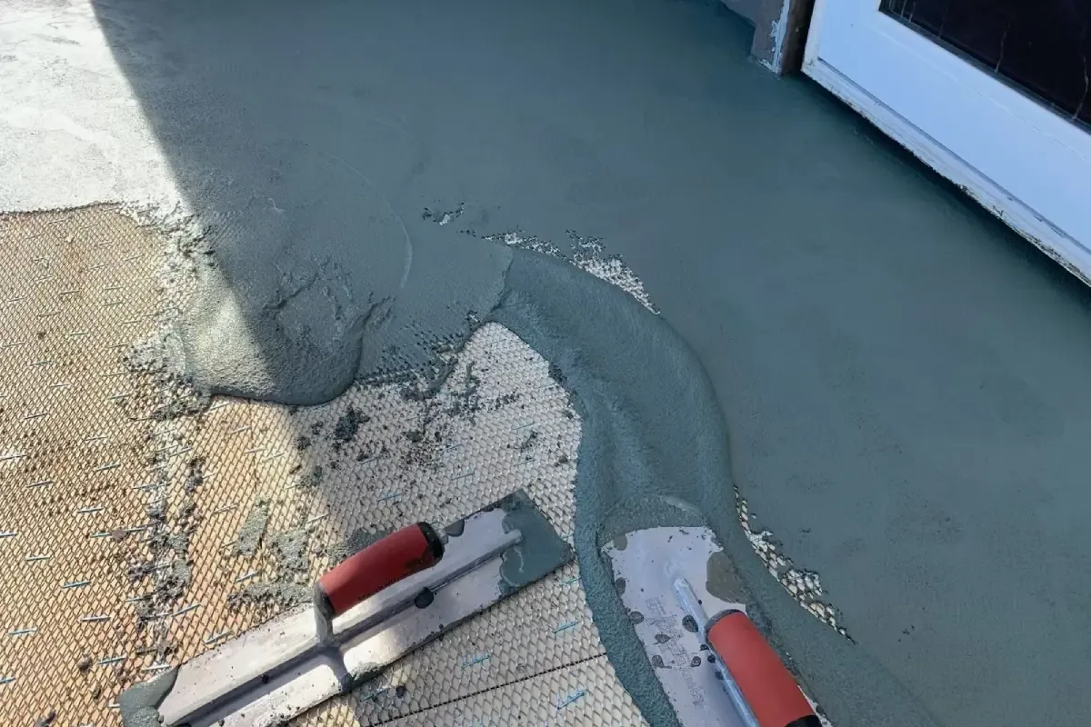 Waterproof deck coating applied over reinforcing mesh with hand trowels