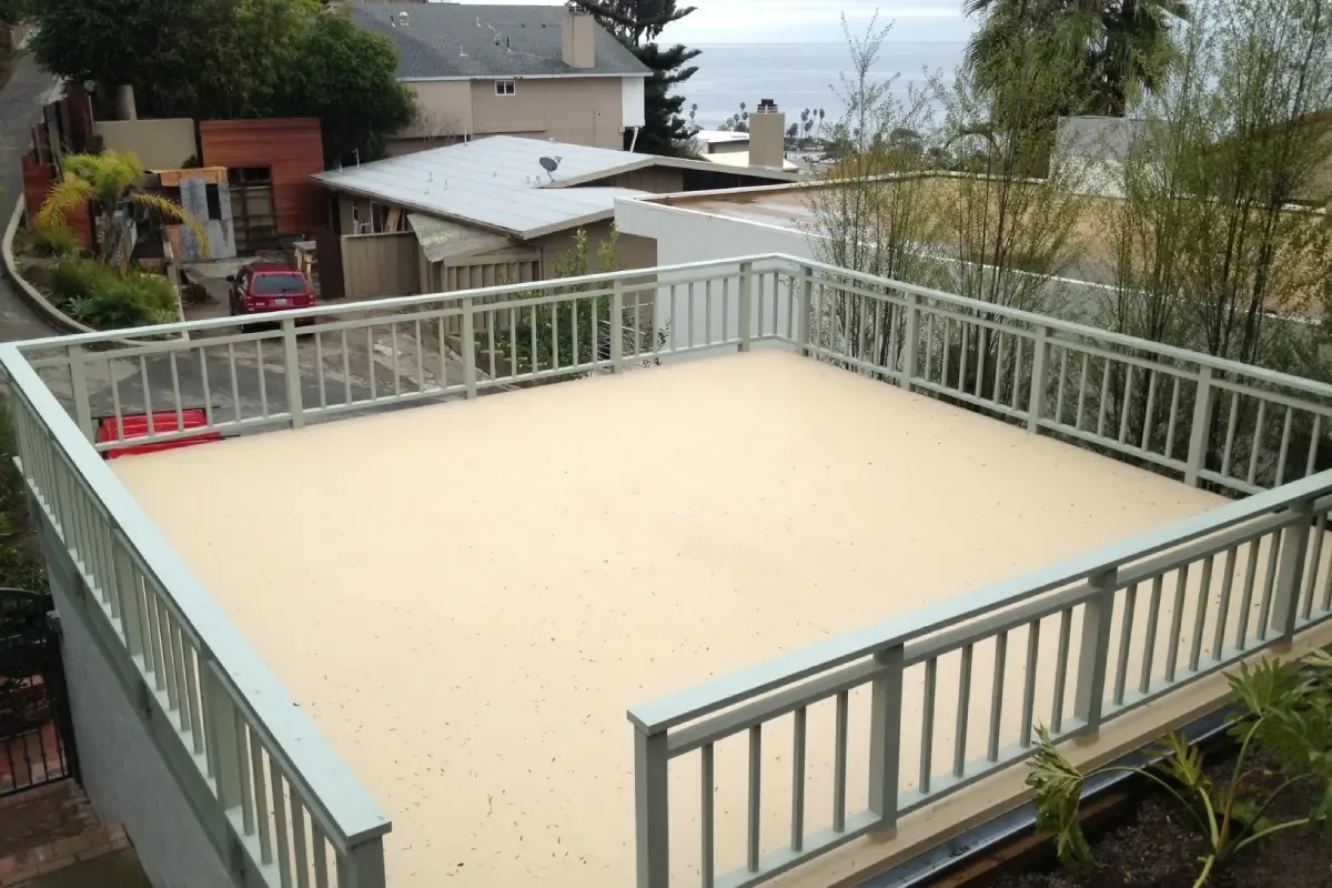 Waterproofed rooftop deck finished with a protective coating